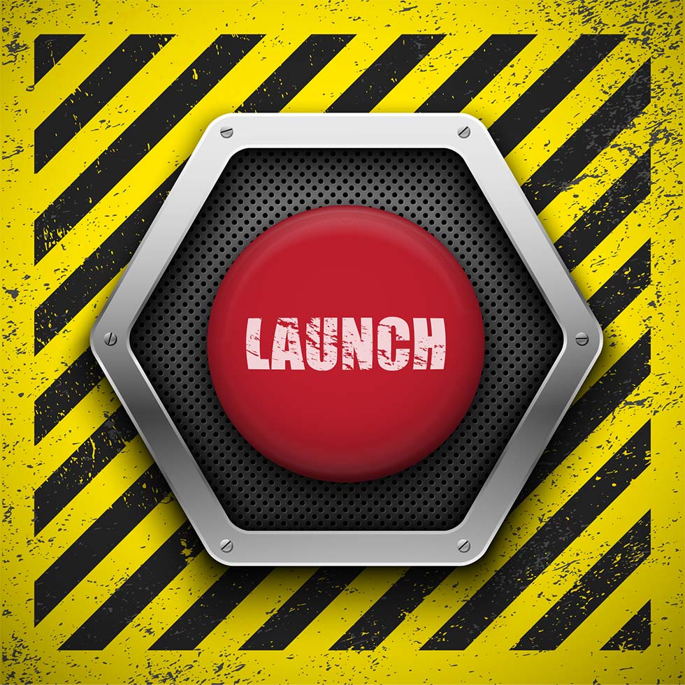 Red launch button on yellow and black striped background