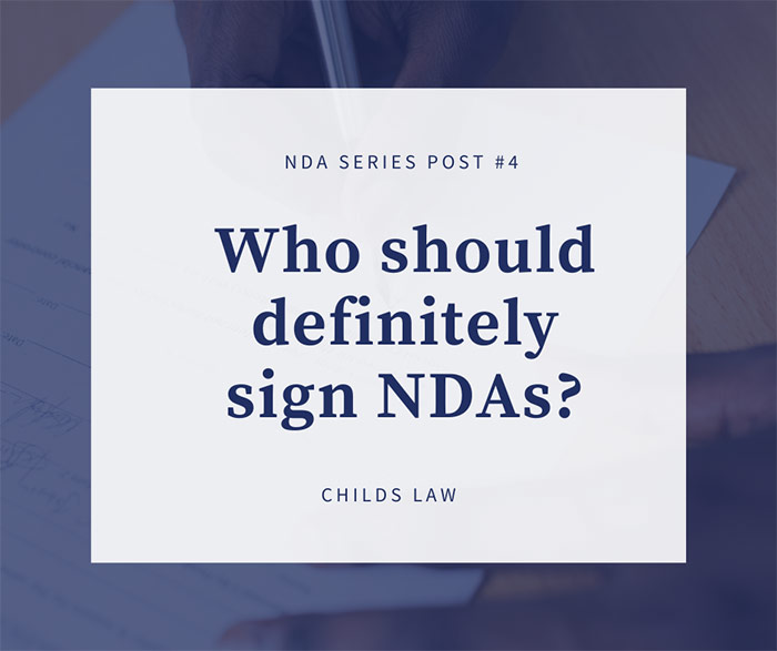 Dark blue serif type over image of person signing a document